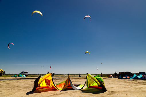 Chascomus, Argentina - October 24, 2021: Kitesurf parachute prepared on the ground on the shore of the Chascomús lagoon
