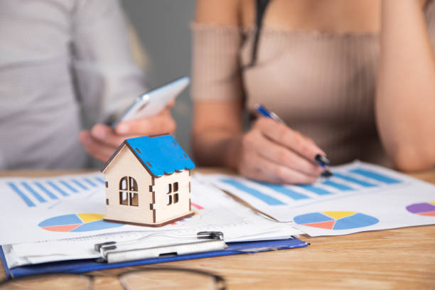 istock businessmen discuss schedules and house 1361617044