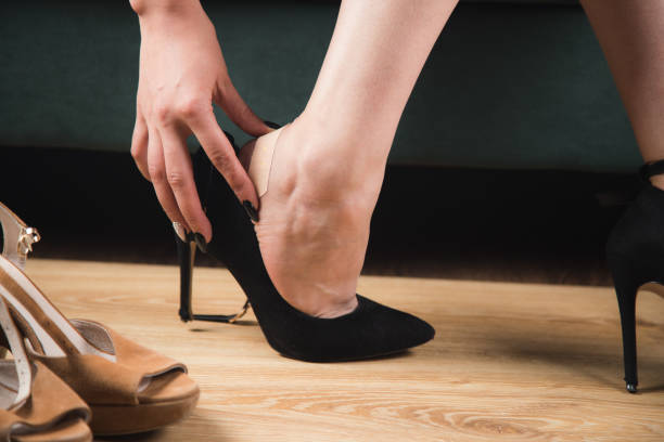 istock woman in high heels glues a plaster 1361617127