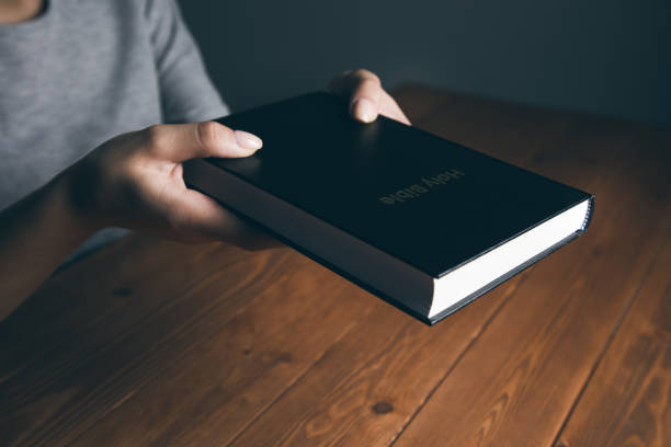 istock woman holding bible at table 1361617444