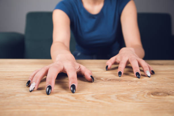 istock woman scratches the table with her nails 1361618560