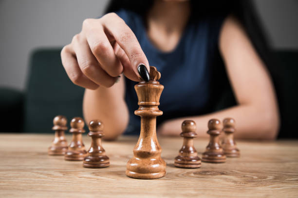 istock young woman playing chess alone 1361618572