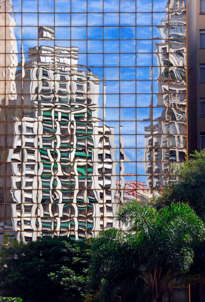 istock Reflection of buildings in blue glass facade 1361618948