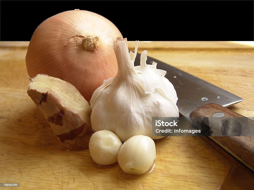 Onion, Garlic & Ginger High resolution digital photo of onion, garlic, ginger and a knife on a cutting board. Asia Stock Photo