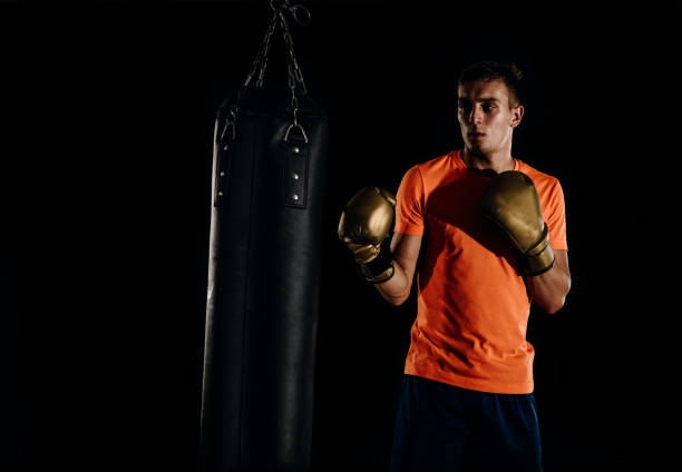 istock Hispanic MMA Fighter practicing some kicks with a punching bag 1361629077