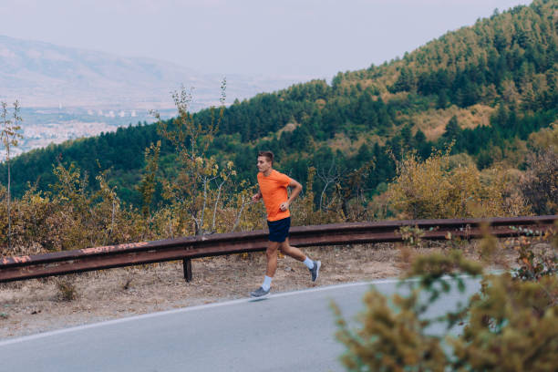 istock Running athlete man. Male runner sprinting during outdoors training on the mountain 1361629107