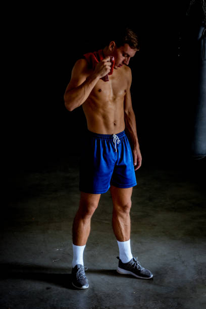 istock Shirtless fighter resting after boxing exercise 1361629625