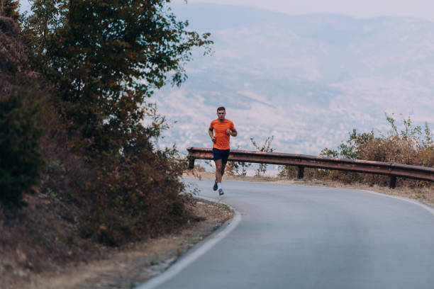 istock Muscular fit sport model sprinter exercising sprint on forest road 1361629654