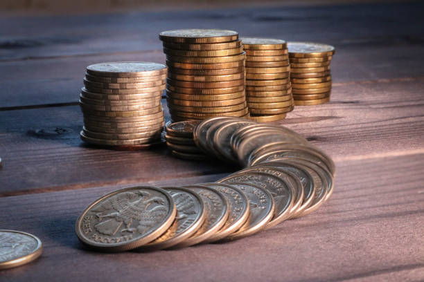istock A stack of coins on a dark wooden surface. Russian metallic rubles. 1361631027