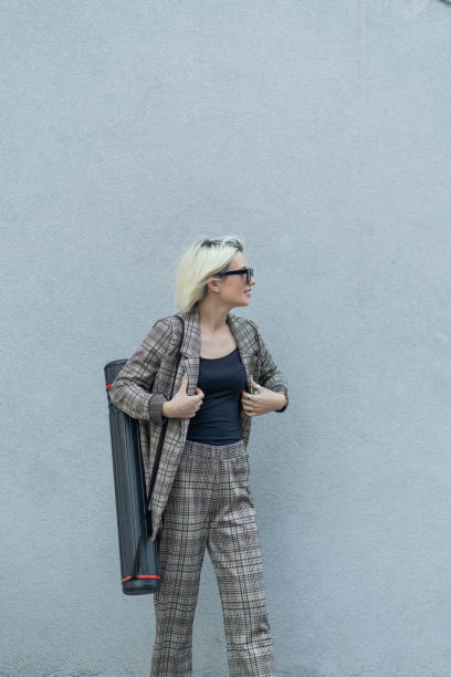 istock Businesswoman is fixing her coat 1361633439