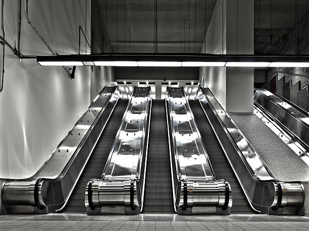 Sets of Working Escalator (wide angle) There is a long exposure picture using HDR technique. It show a bit of movement and motion. the stairs are blurry and there is no people in this scene. This was shot in the Montreal metro (subway). This is one of the biggest metro station in Montreal. montreal underground city stock pictures, royalty-free photos & images