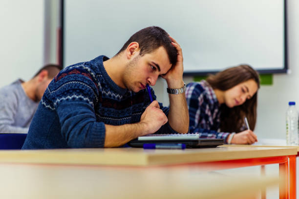istock Stressed college student for exam in classroom 1361637449