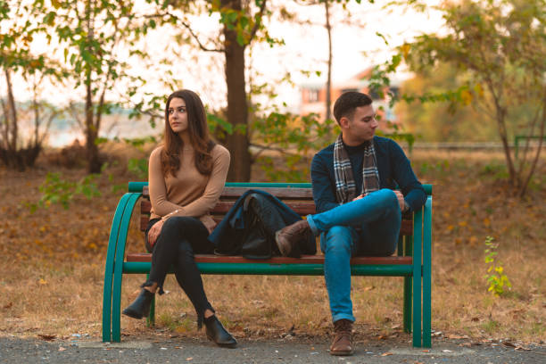 istock Angry couple sitting on a bench and looking in opposite directions. 1361641072