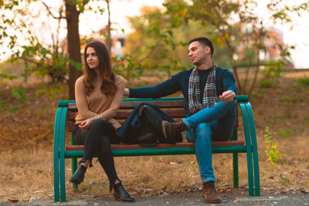 istock Angry girlfriend  ignoring her boyfriend while he is trying to apologize. 1361641075