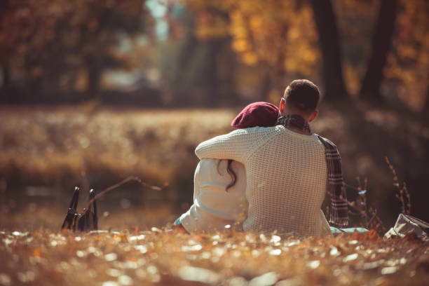 istock Stylish couple hugging near the river 1361641115