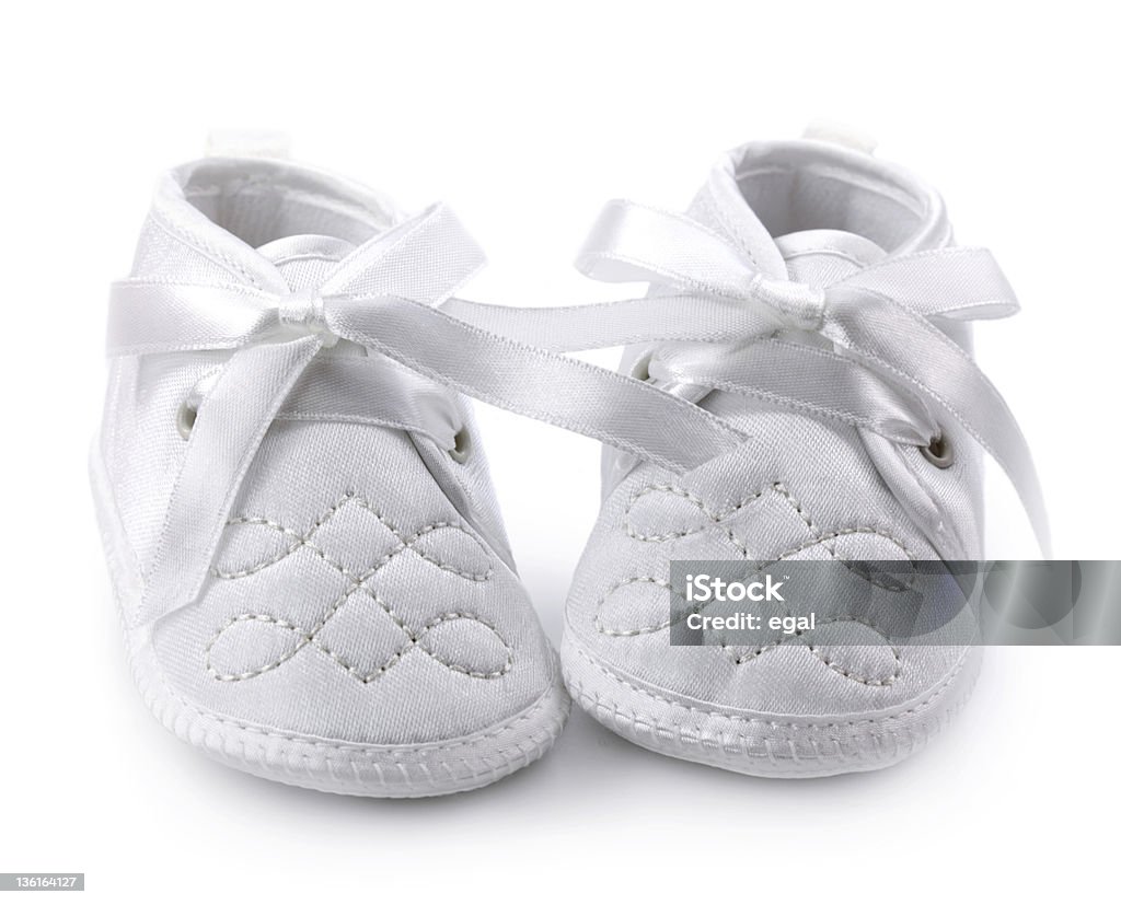 White baby shoes against white background Baby shoes isolated on white background Baby Booties Stock Photo