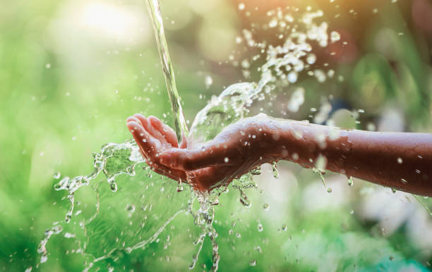 istock Water pouring on hand in morning ligth background 1361654710