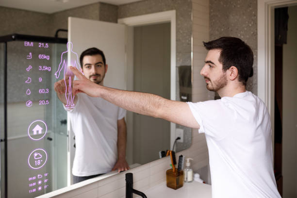istock Young man using mirror touch screen to look at the data given about his health 1361654812