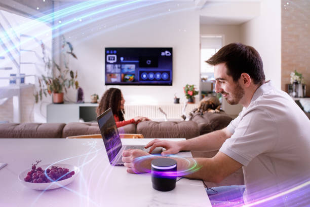 Couple using smart speaker while doing other everyday tasks Couple using technologies of smart home on daily tasks home automation stock pictures, royalty-free photos & images
