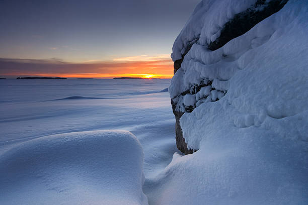istock Snowy beach rocks in morning dawn 136166073
