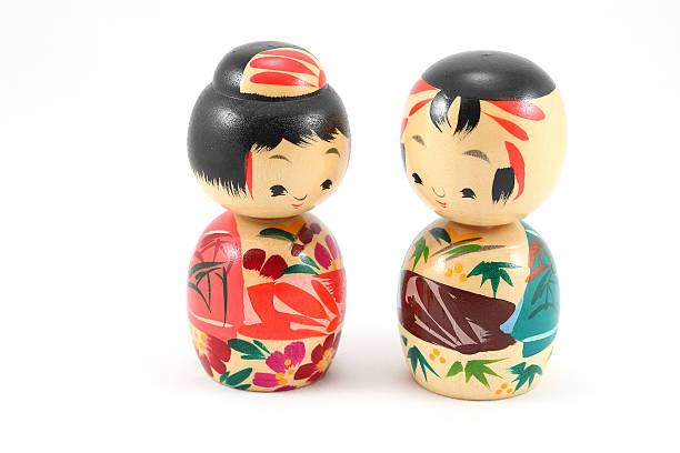 Japanese doll still life, white background. Wood.