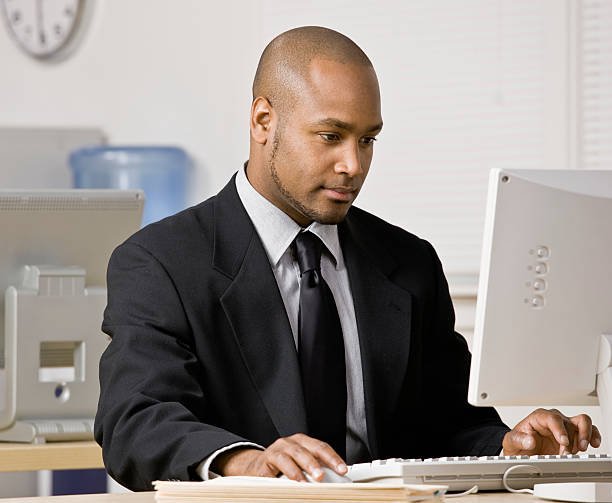 istock Serious businessman typing on computer at desk 136166407