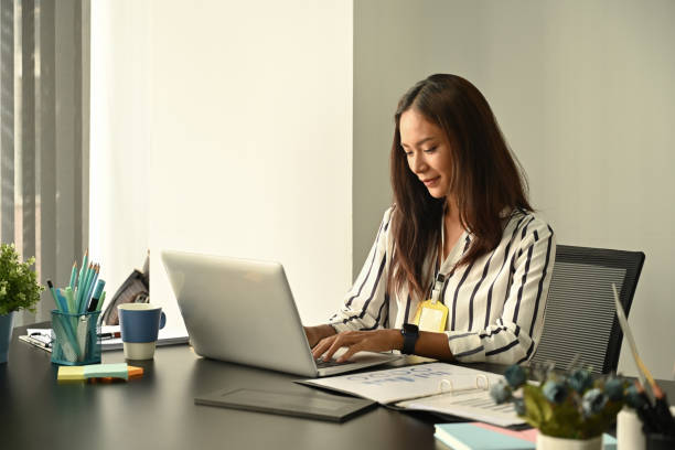 istock Charming businesswoman working with laptop at her workplace. 1361666050