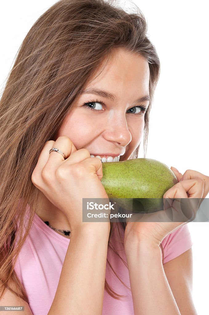 Young happy woman biting pear Young happy woman biitng peach isolated on white Adult Stock Photo