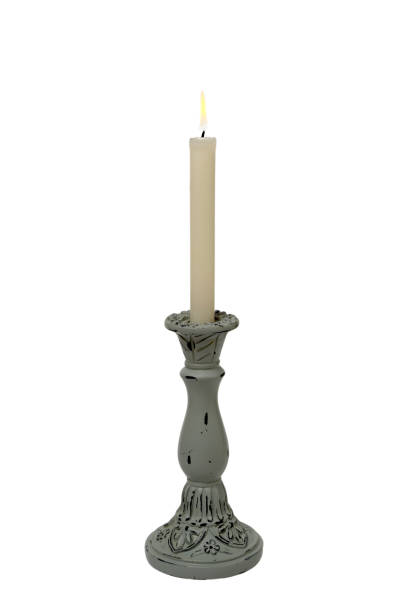 istock Burning candle in an old retro candle holder on a white background. 1361668558