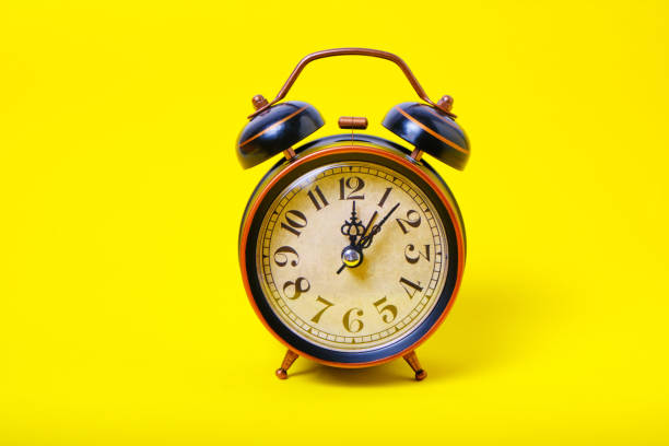 istock Alarm clock on a yellow background, bright and sunny. 1361668571