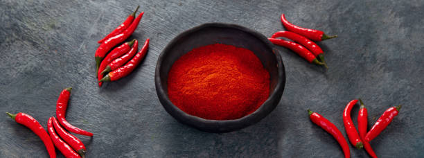 istock Red chili or chilli cayenne pepper on dark background. 1361669325