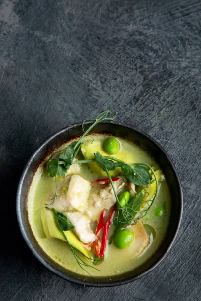 istock Green curry with chicken in bowl on dark background. 1361669429