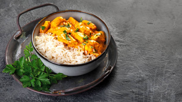 istock Indian butter chicken curry with basmati rice on dark background. 1361669467