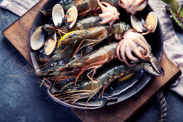 istock Raw shrimps on dark background. 1361670132