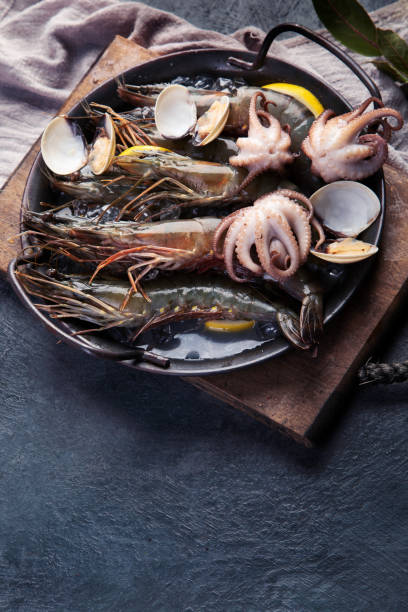 istock Raw shrimps on dark background. 1361670285