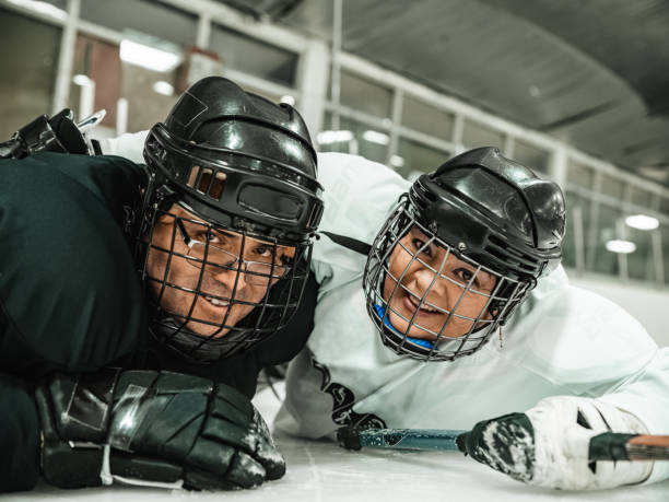 istock Latin woman and her partner practising sledge hockey 1361674653