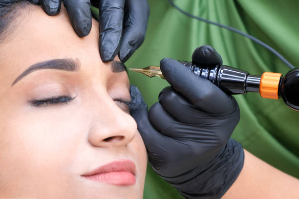 istock Beautician makes permanent eyebrow makeup on the face 1361679841