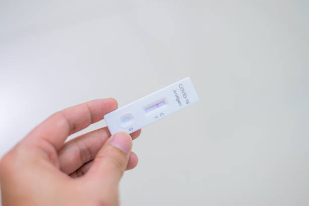 istock Human's hand holding Negative result shows on rapid test kit for COVID-19 1361679887
