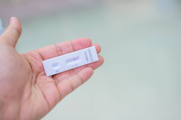 istock Human's hand holding Negative result shows on rapid test kit for COVID-19 1361679940
