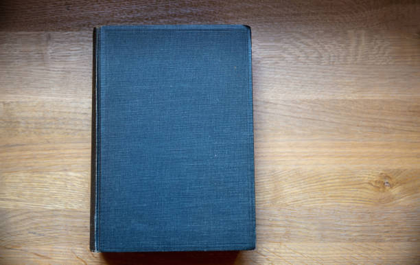 istock Closed old black book on a table. Blank cover notebook on wooden background, top view. Copy space 1361682511
