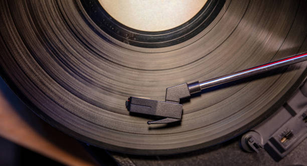 istock Turntable vinyl record player. Needle on the disc, close up top view. 1361682525