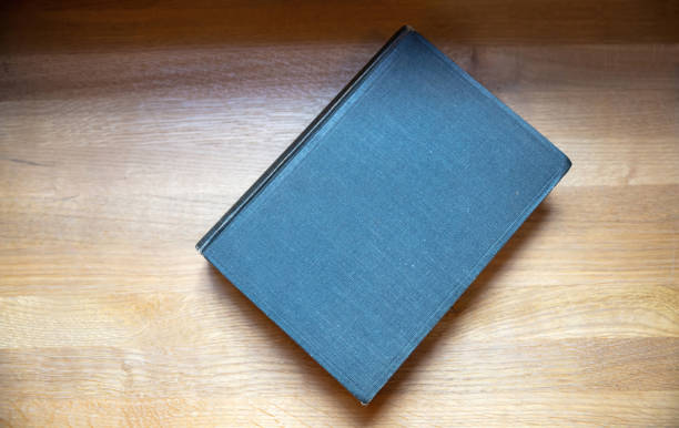 istock Closed old black book on a table. Blank cover notebook on wooden background, top view. Copy space 1361682575