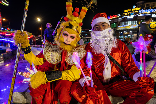 Da Lat, Lam Dong, Vietnam - December 18, 2019: Santa Claus and a traditional monkey man in Dalat in Vietnam