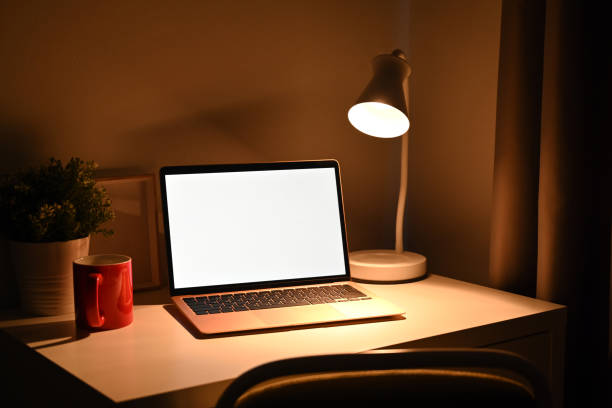 istock Mock up computer laptop with warm light from lamp at night. 1361683758