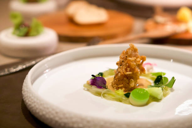 istock Deep fried Blue Lobster from Brittany with puffed rice served on slice cucumber, decorated with oxalis flower. Modern French cuisine. 1361683858