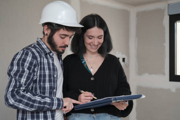 istock Young woman signing a document for buying house in construction. 1361684389
