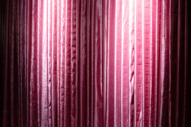 istock Theater curtain in red with backlighting. 1361684430