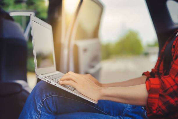 istock female operating pc at car 1361684660