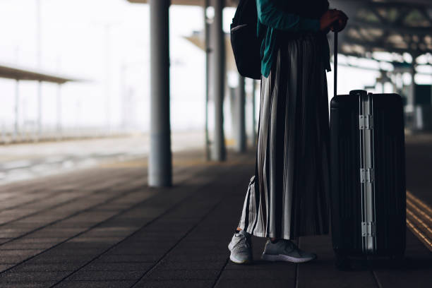 istock suitcase and asian female tourist 1361684690
