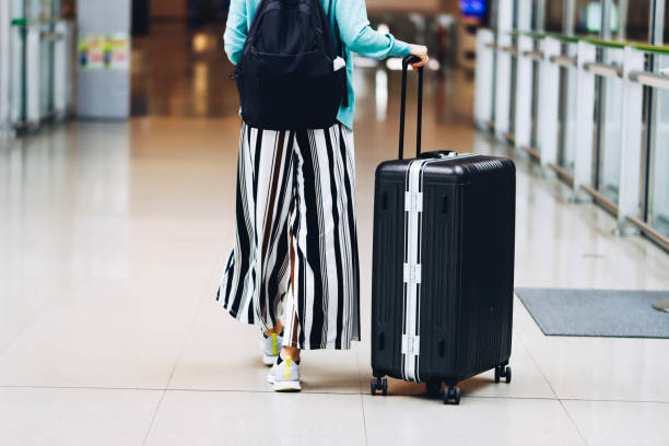 istock suitcase and asian female tourist 1361684692